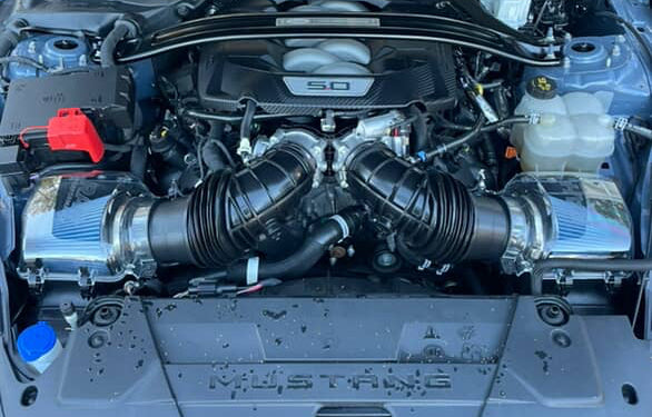 Mustang engine compartment with 'RAH' branding on a clear airbox covers