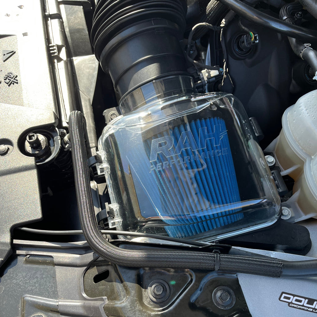 Close-up of a clear air filter  cover with 'RAH' branding.