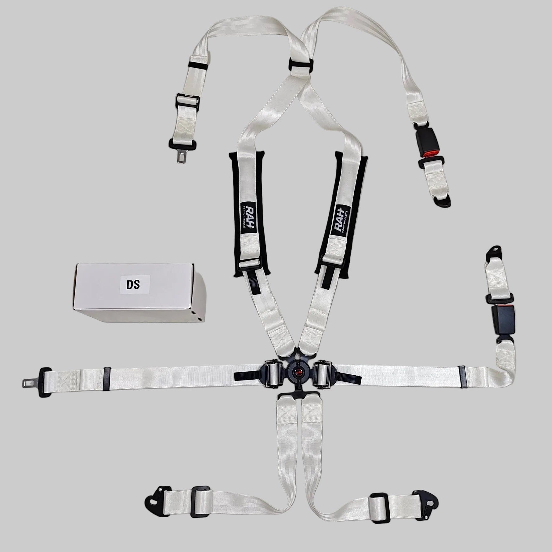 Set of car safety harnesses on a gray surface with a 'DS' label.